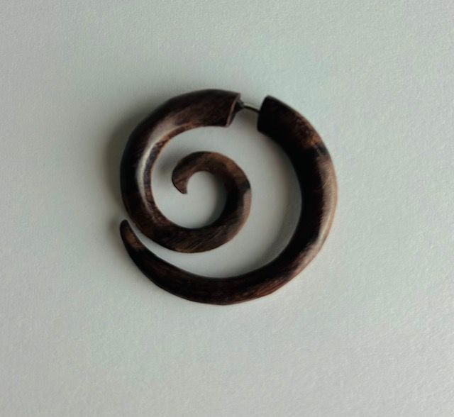 Dark brown wooden spiral earring.