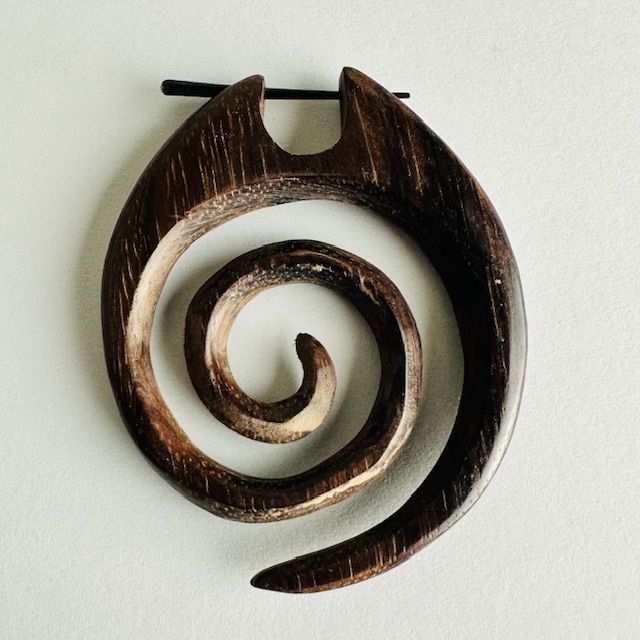 Wooden spiral earring, dark brown, with a black bar for hanging.
