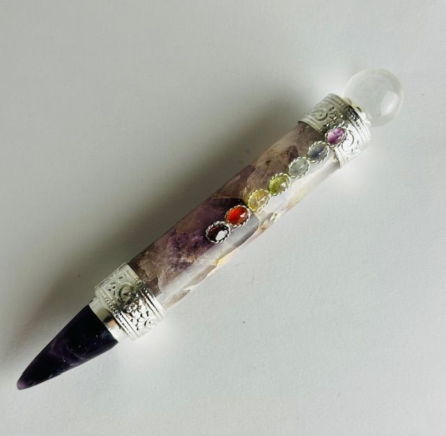 Crystal wand with purple, silver, and colorful stones; clear crystal ball at the top, pointed tip.