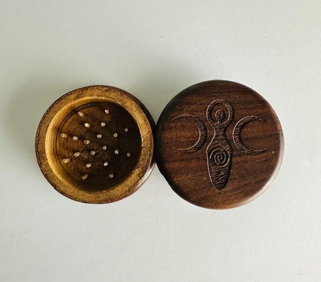 Wooden herb grinder, open. Top lid with engraved triple goddess symbol.