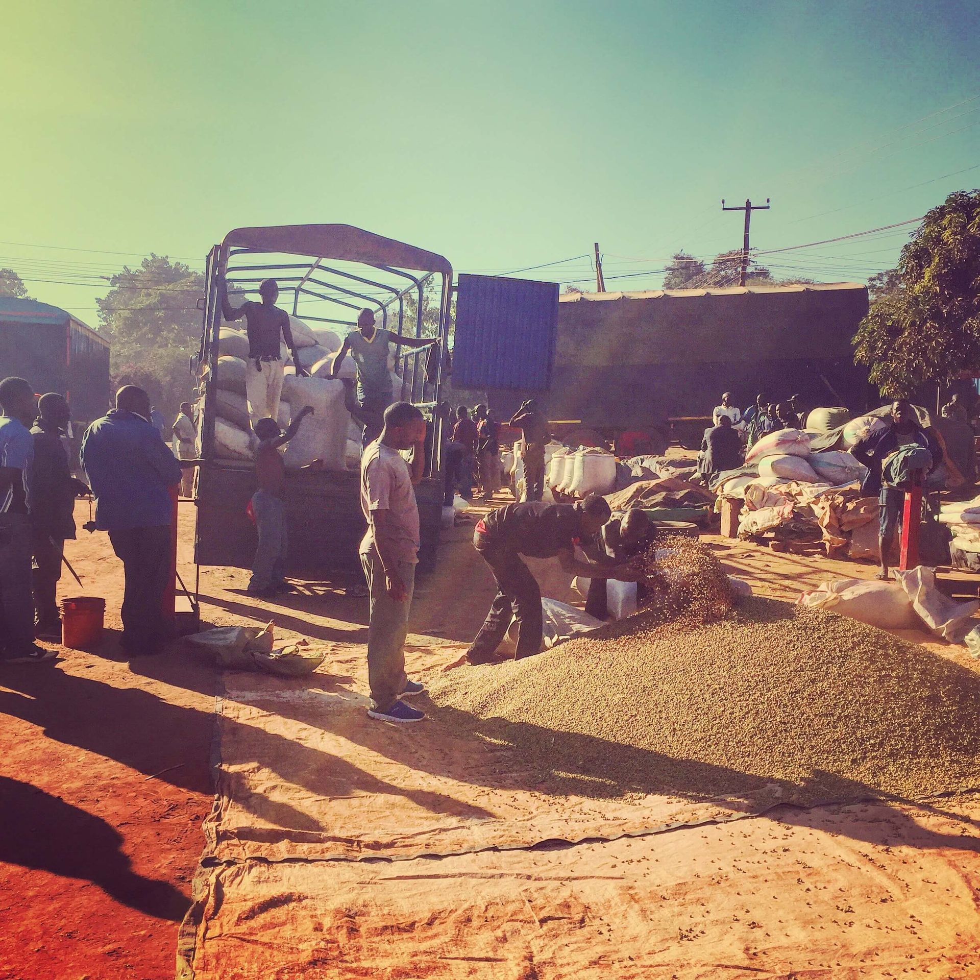 A group of people are standing in front of a truck