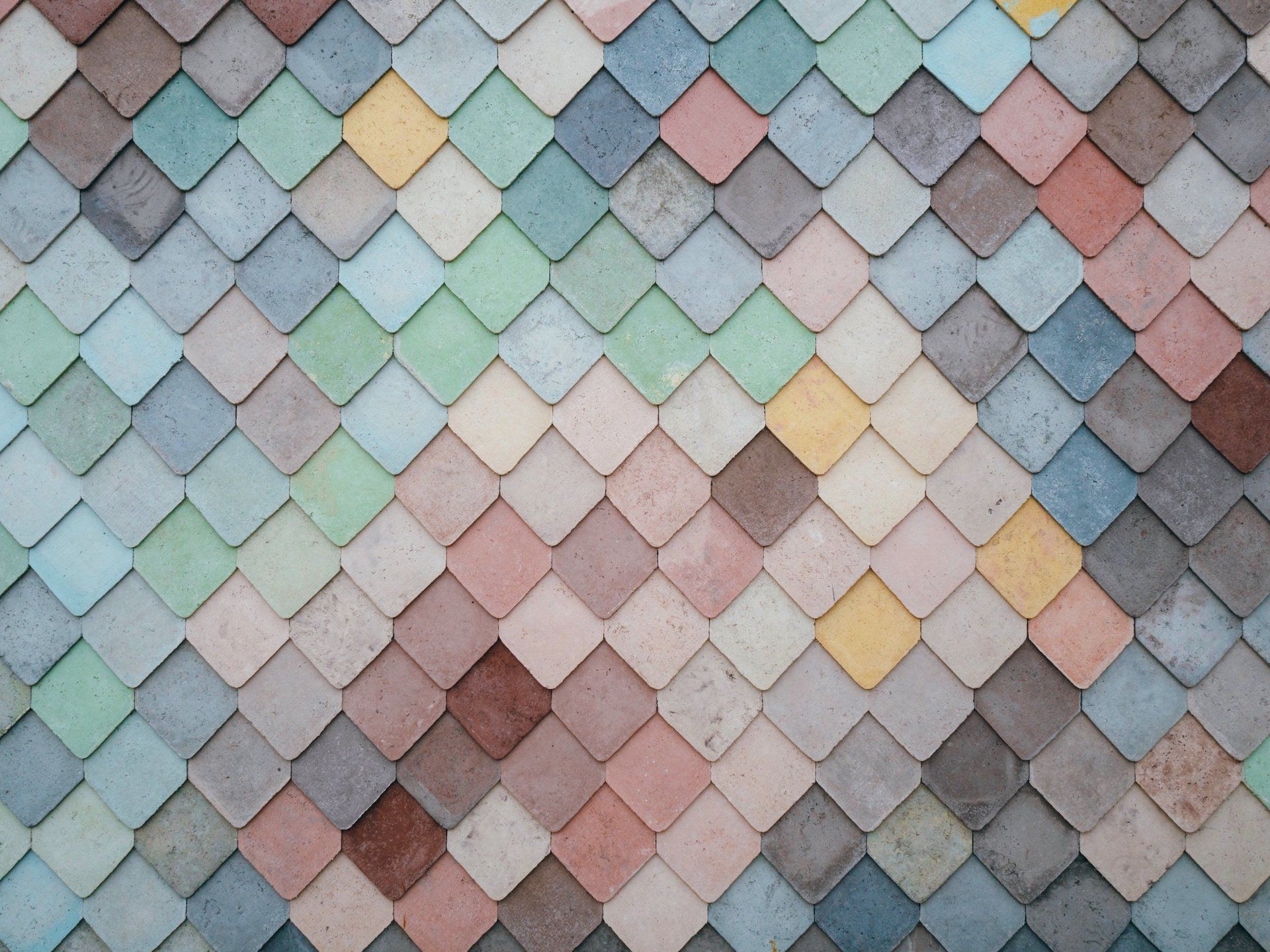 Pastel-colored overlapping fish-scale tiles in a geometric pattern