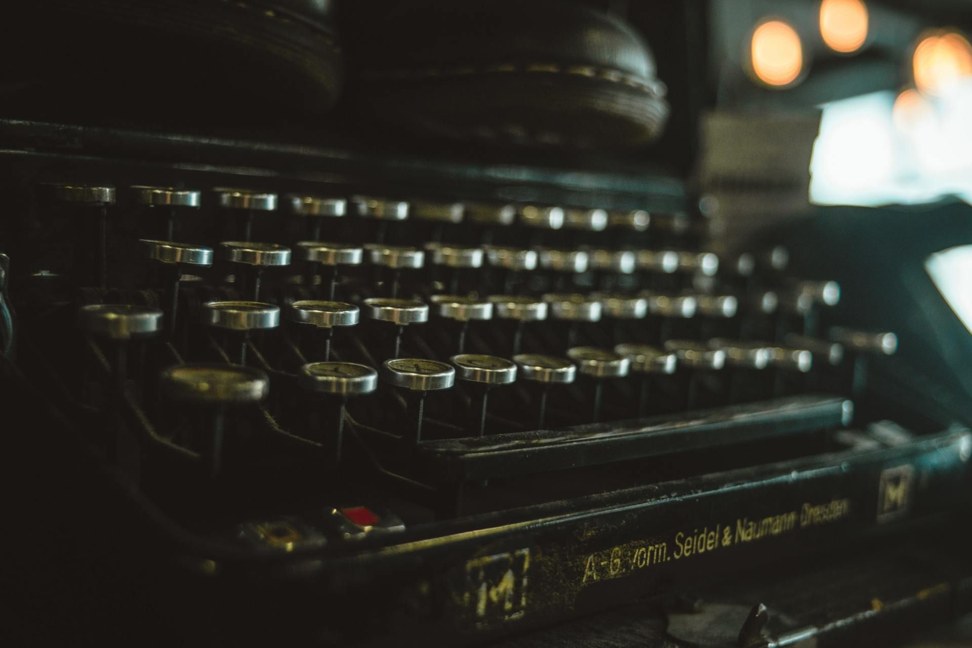 Close-up of a vintage typewriter with dark keys in low light
