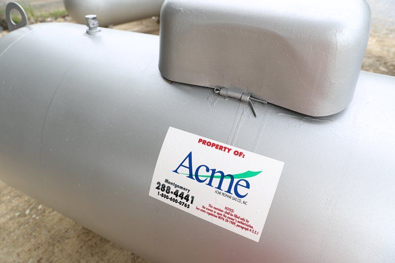 A gray cylinder with a sticker that says aeme on it