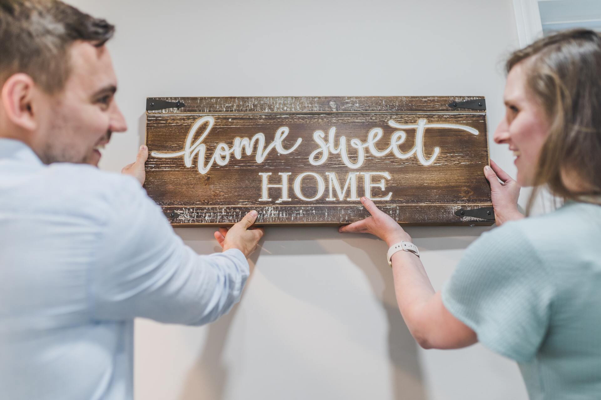 Two people hanging a rustic