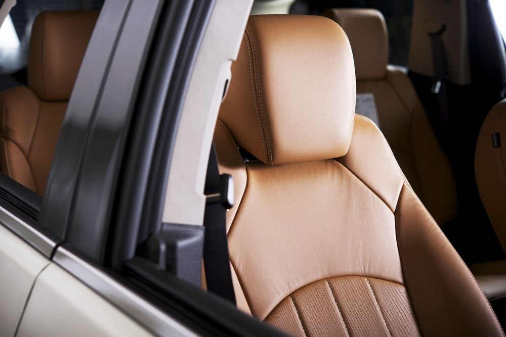 A close up of a brown leather seat in a pickup truck.