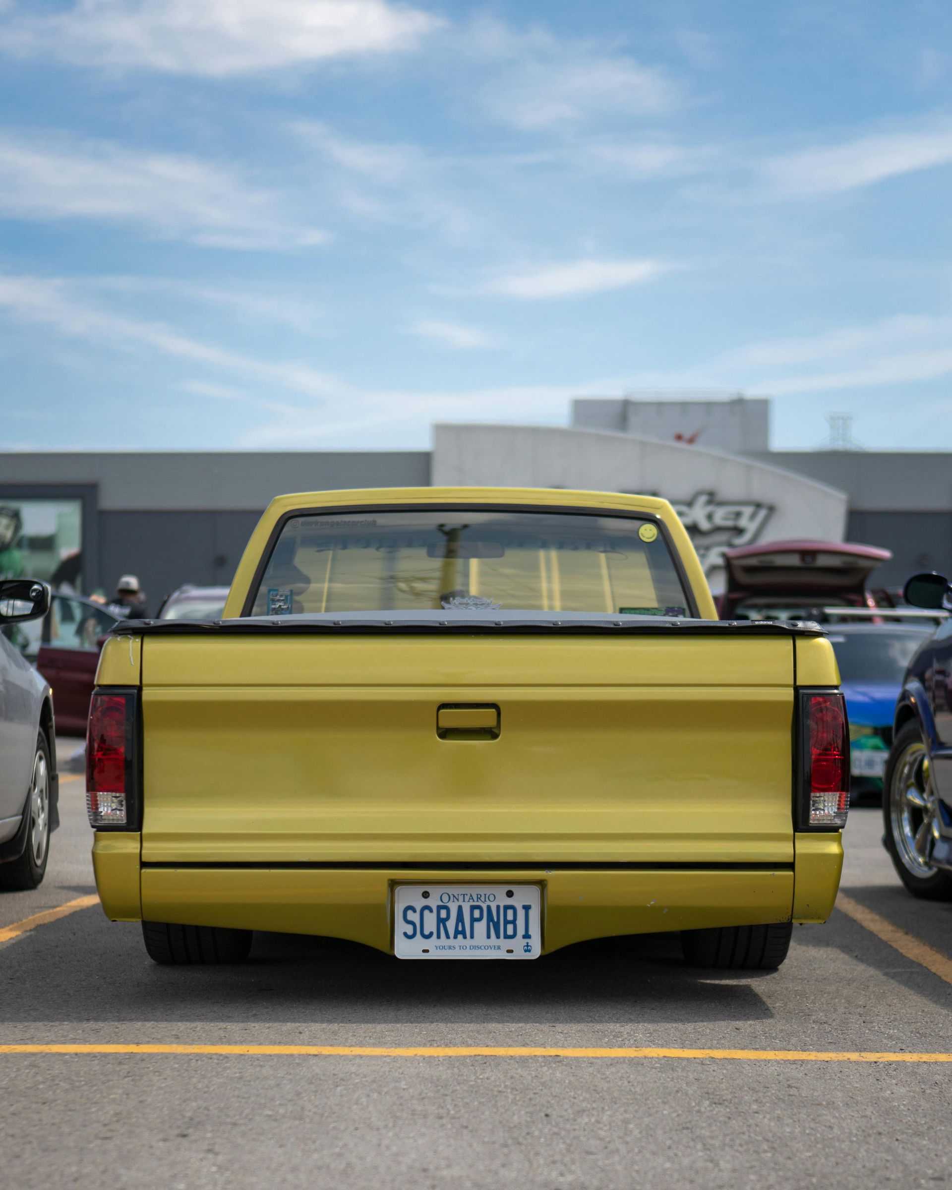 A yellow truck in a parking space.