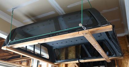 A canopy is hanging from the ceiling in a garage.