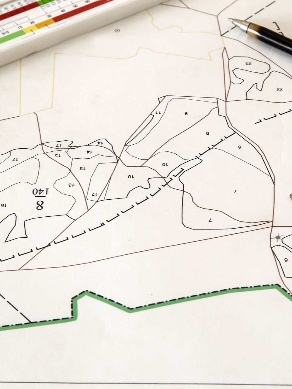 Hand-drawn map on white paper with black dashed boundaries and green highlighted edge along the bottom