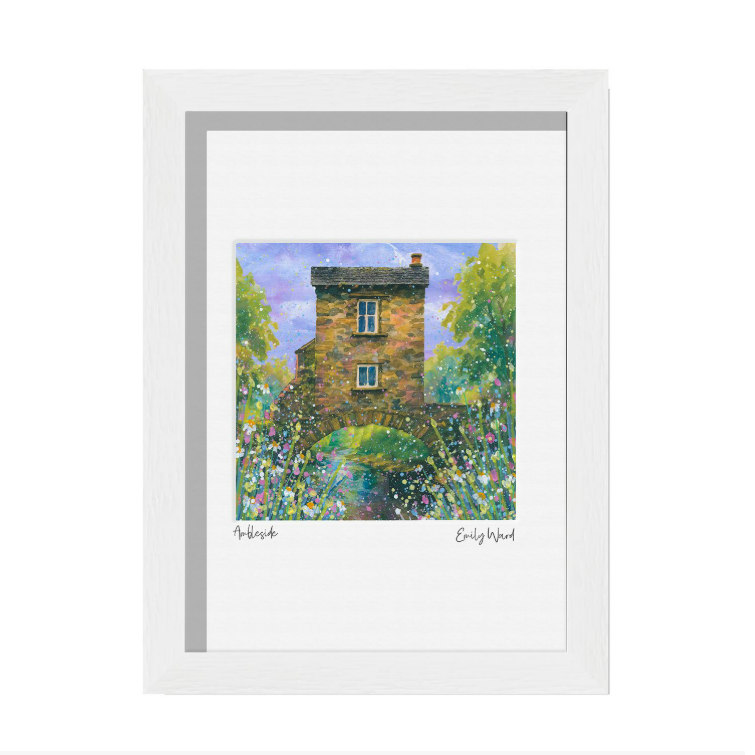 Framed print of a colorful house surrounded by trees and flowers, with handwritten text at the bottom