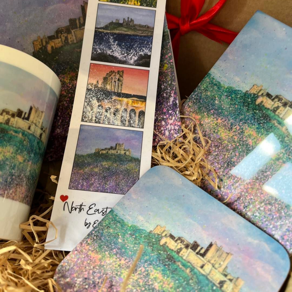 Photo collage cards and a notebook with scenic city prints, arranged on straw with a red ribbon.