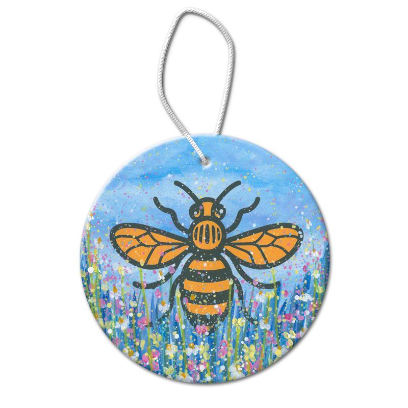 Round bee ornament with orange-and-black bee on a blue floral background and silver hanging loop