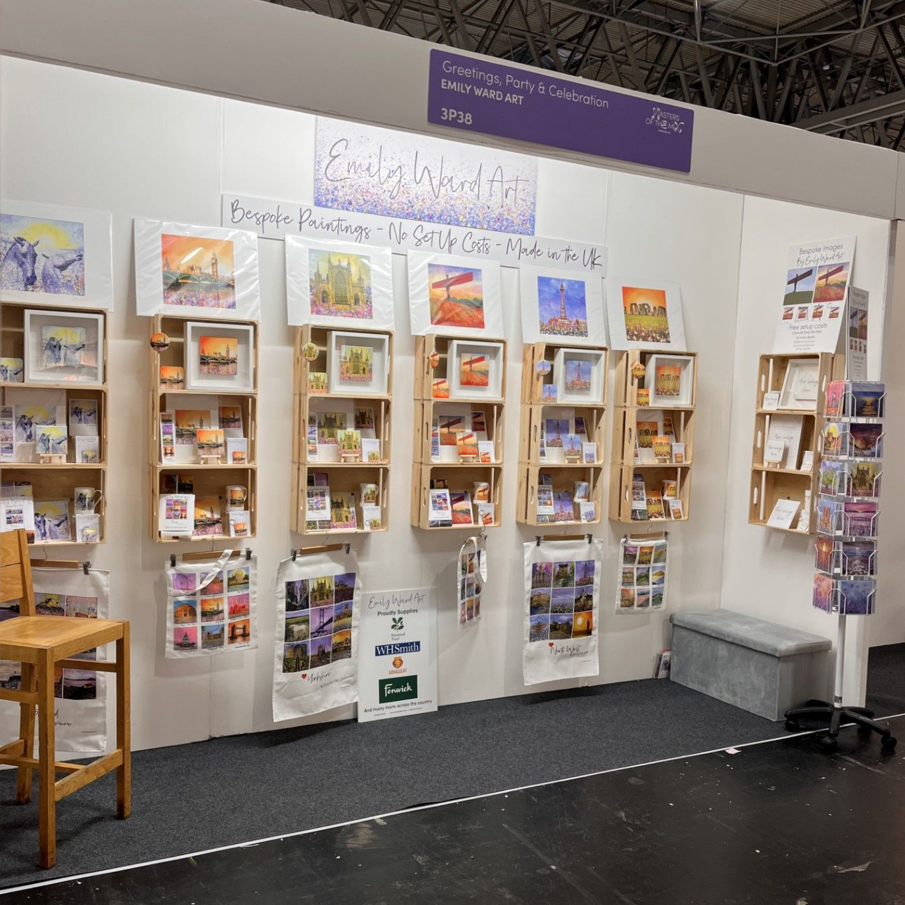 Book display booth with shelves of colorful books and brochures at an indoor fair.
