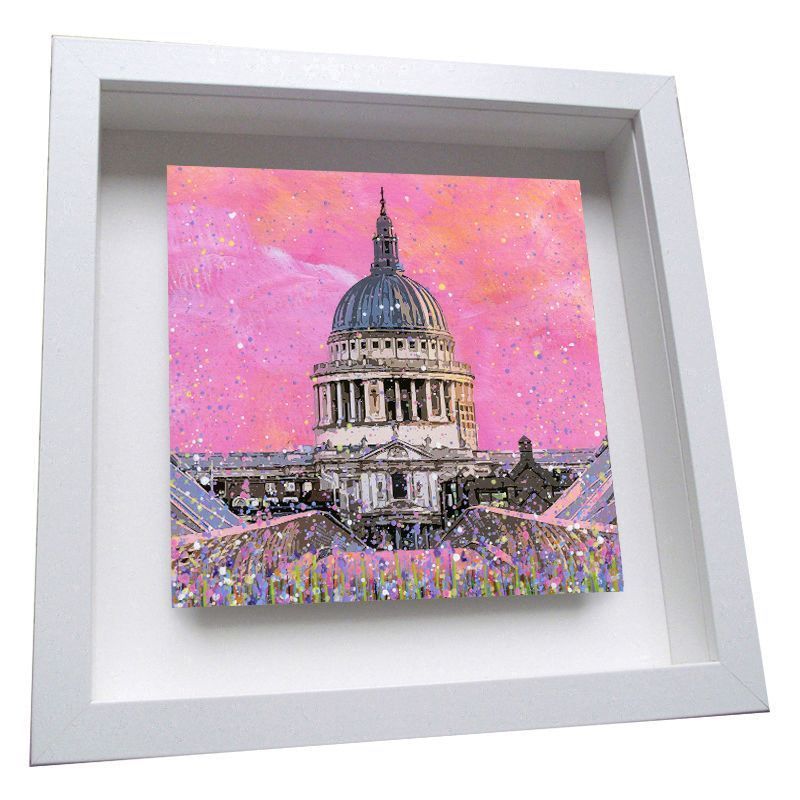 Framed painting of a domed cathedral against a pink sky, with a colorful crowd below.