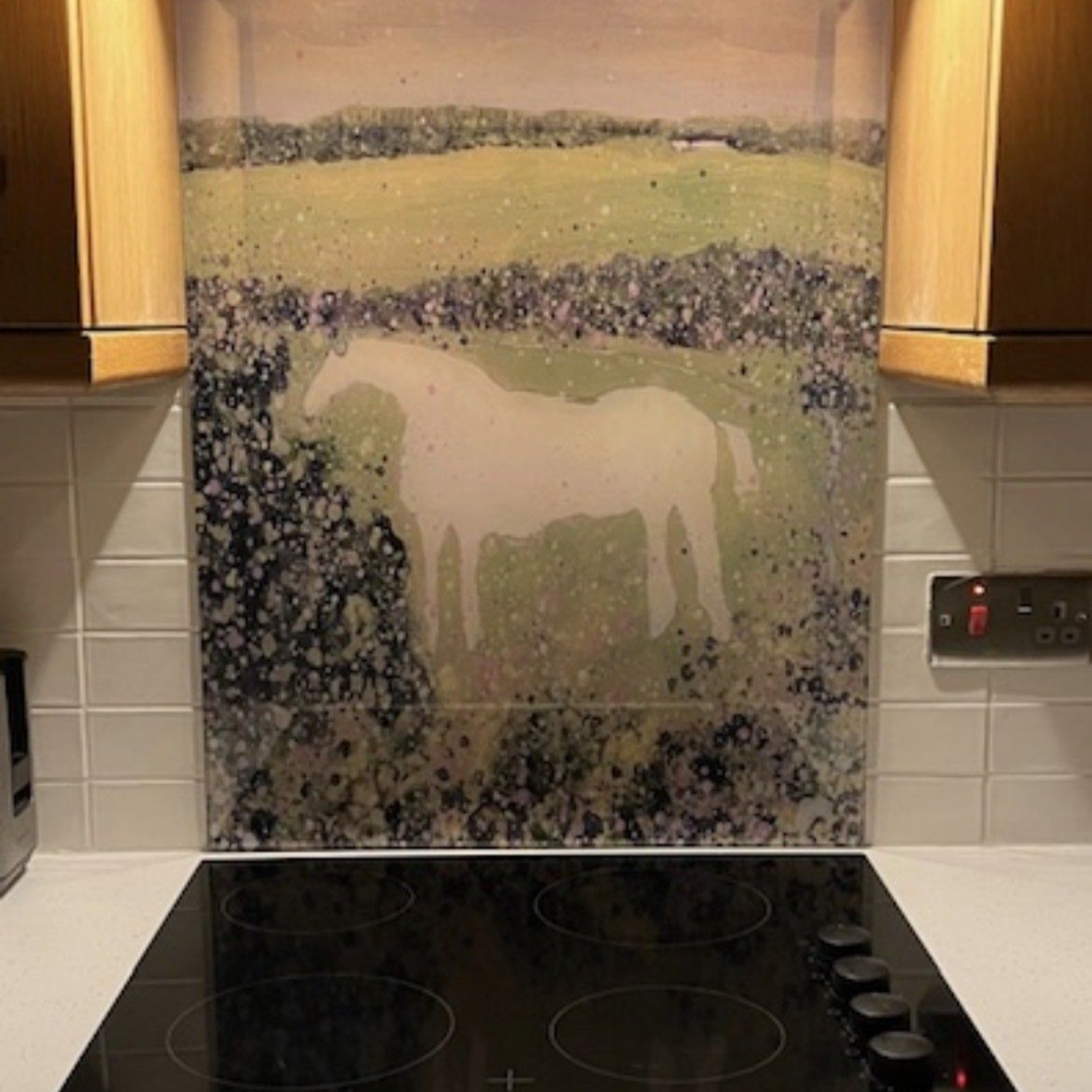 Kitchen stove with a horse mural backsplash in soft pastel colors