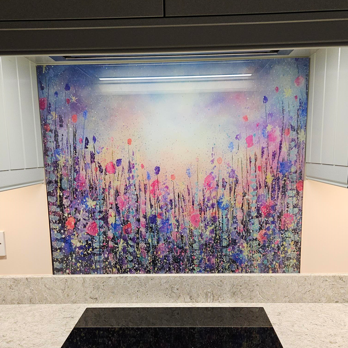 Abstract floral-style mural in pink, blue, and white on a wall in a tiled interior space