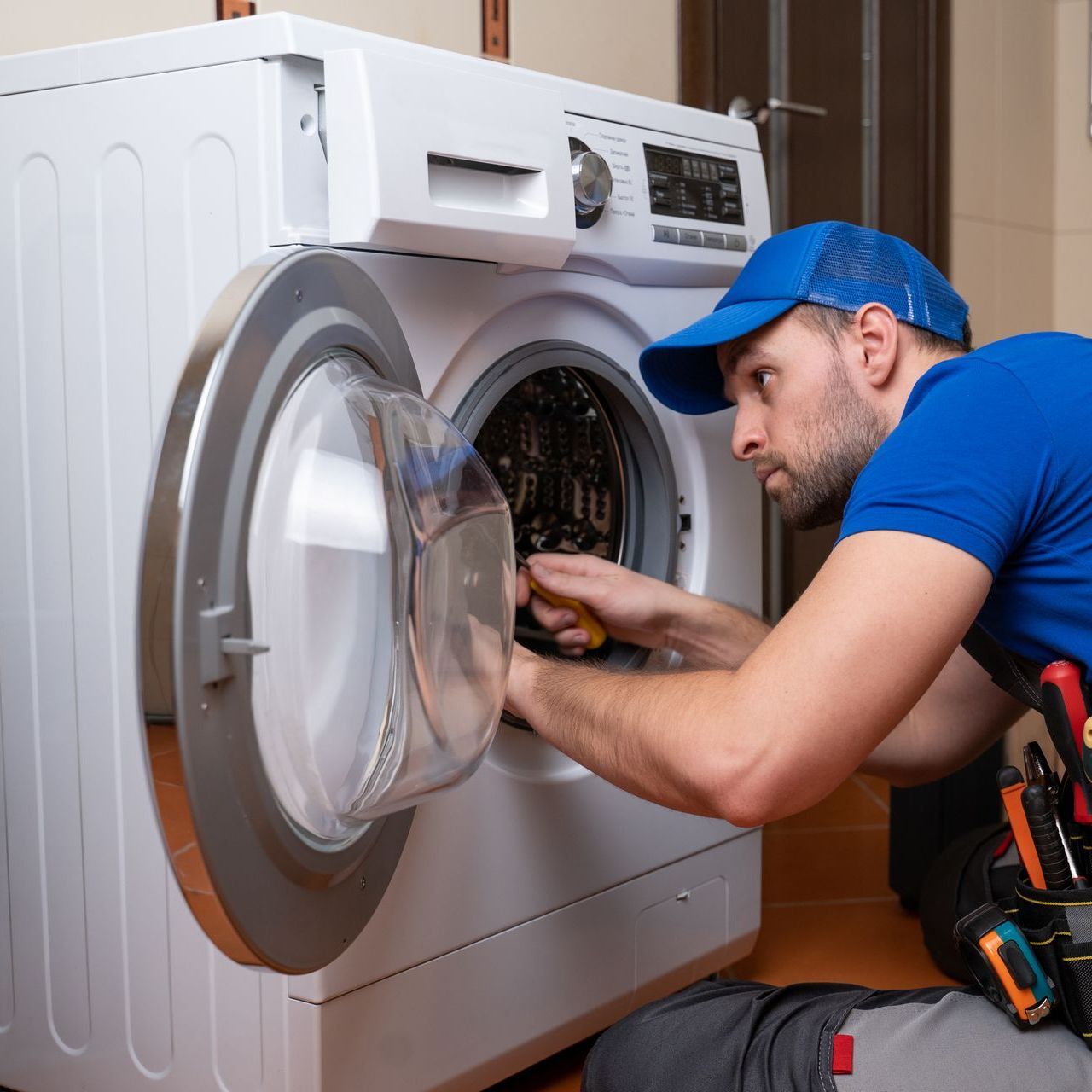 technician repairing washing machine