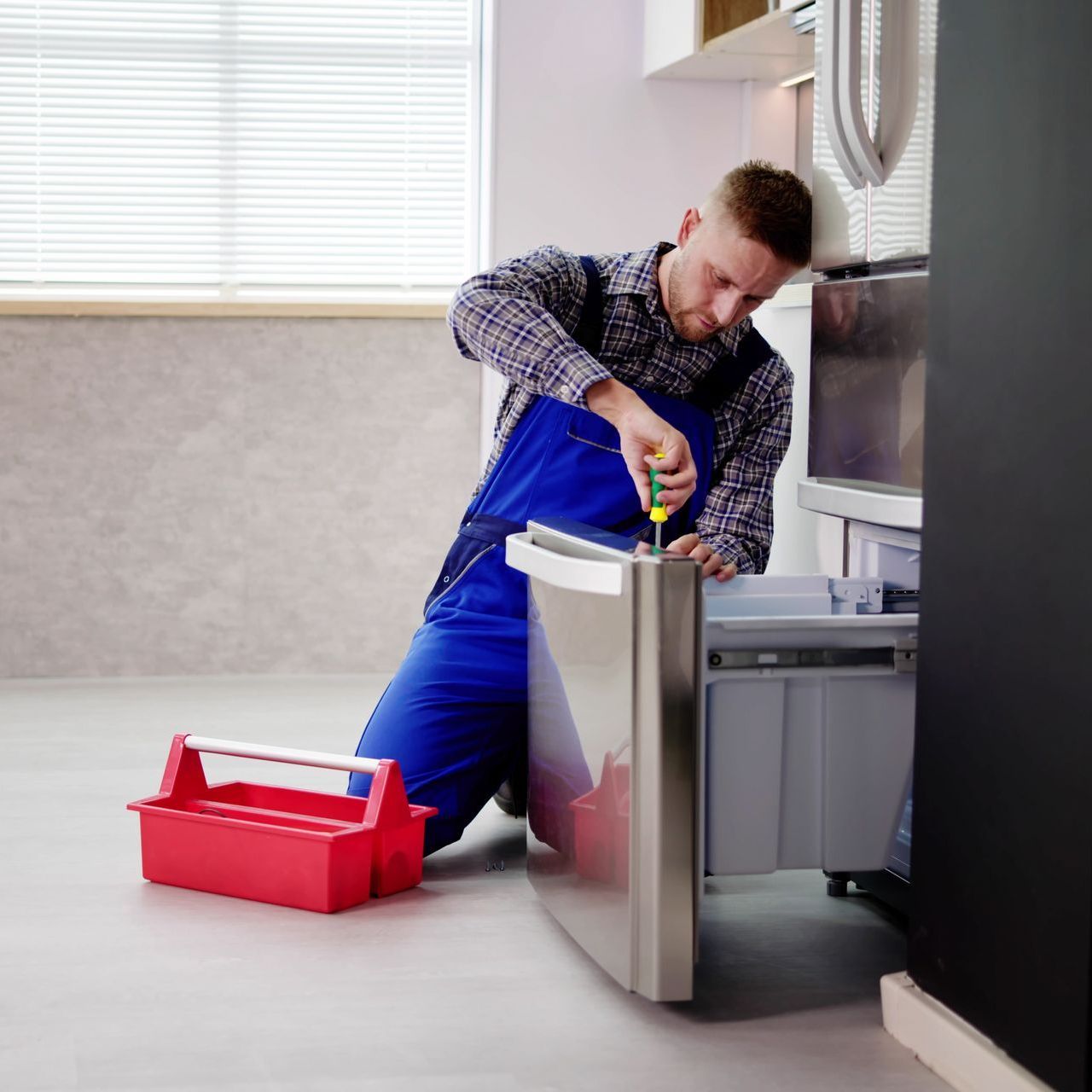 technician performing repairs to freezer