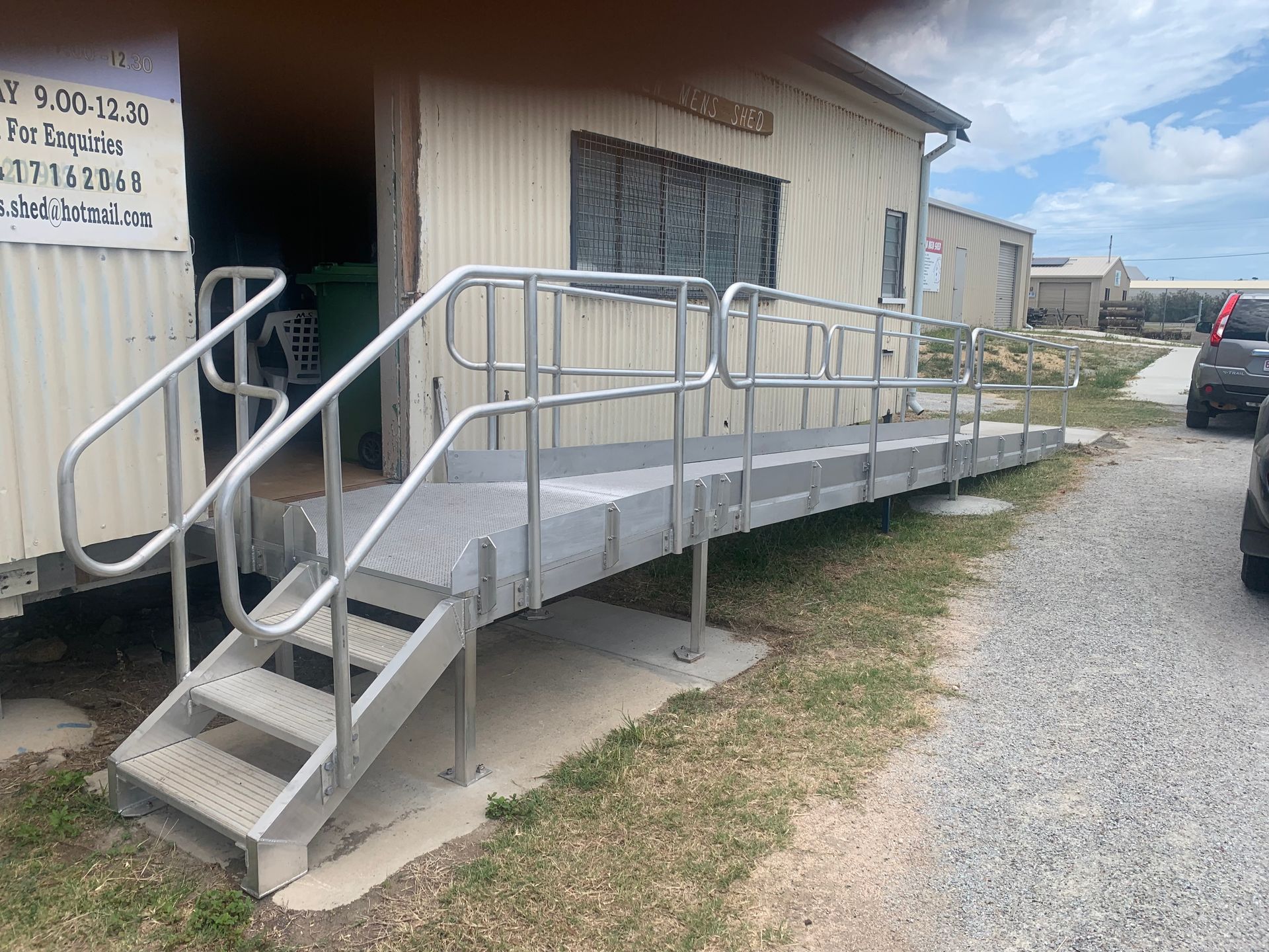 Accessible Metal Ramp With Railings Leading To A Beige Building Entrance — Kaplan Engineering Pty Ltd In Bowen, QLD