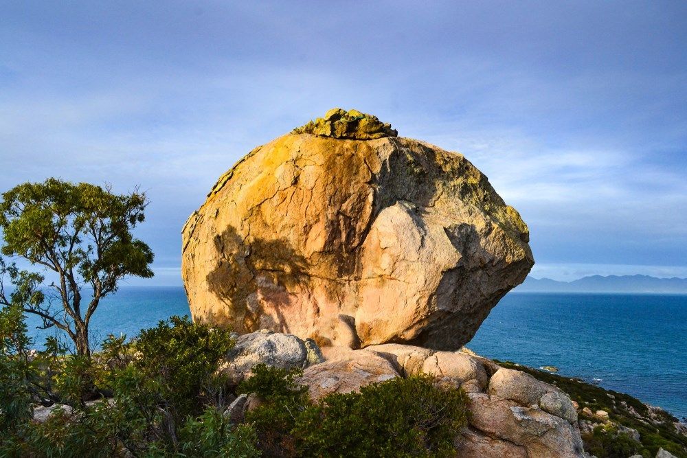 A Large Rock Sitting On Top Of A Cliff Overlooking The Ocean — Kaplan Engineering Pty Ltd In Bowen, QLD