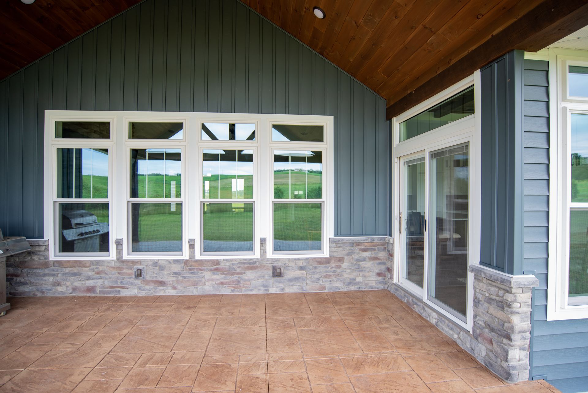 A house with a lot of windows and sliding glass doors