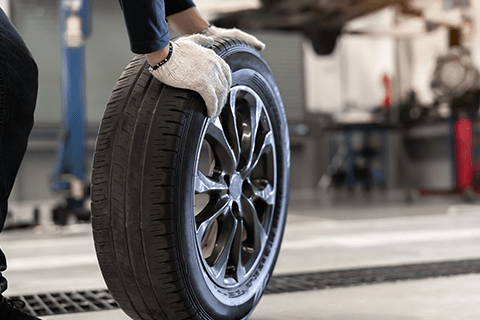 Worker Fixing Wheel — Monroe, NC — Small Bros. Tire Co Inc. Worker Fixing Wheel — Monroe, NC — Small Bros. Tire Co Inc.