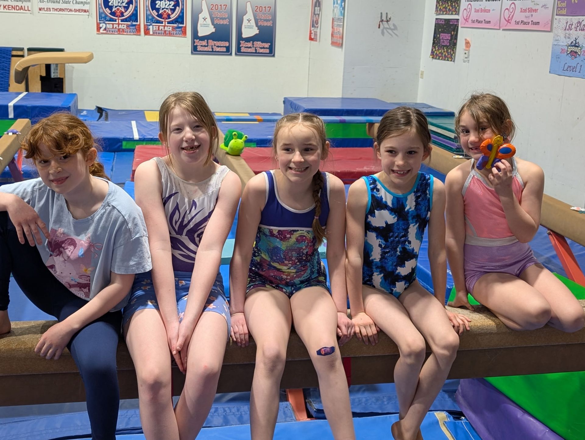 Gymnasts sitting on beam