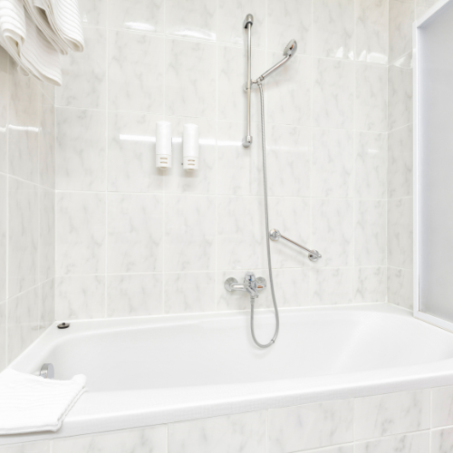 A bathroom with a bathtub and a shower.