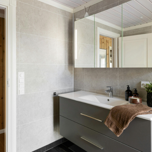 A bathroom with a sink and a mirror above it