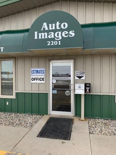 Exterior view of Auto Images body shop at 2201 with green trim, a glass front door, and an office sign.