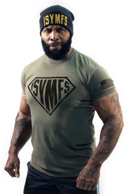 Man in olive SYMFS shirt and black beanie, standing against a white background