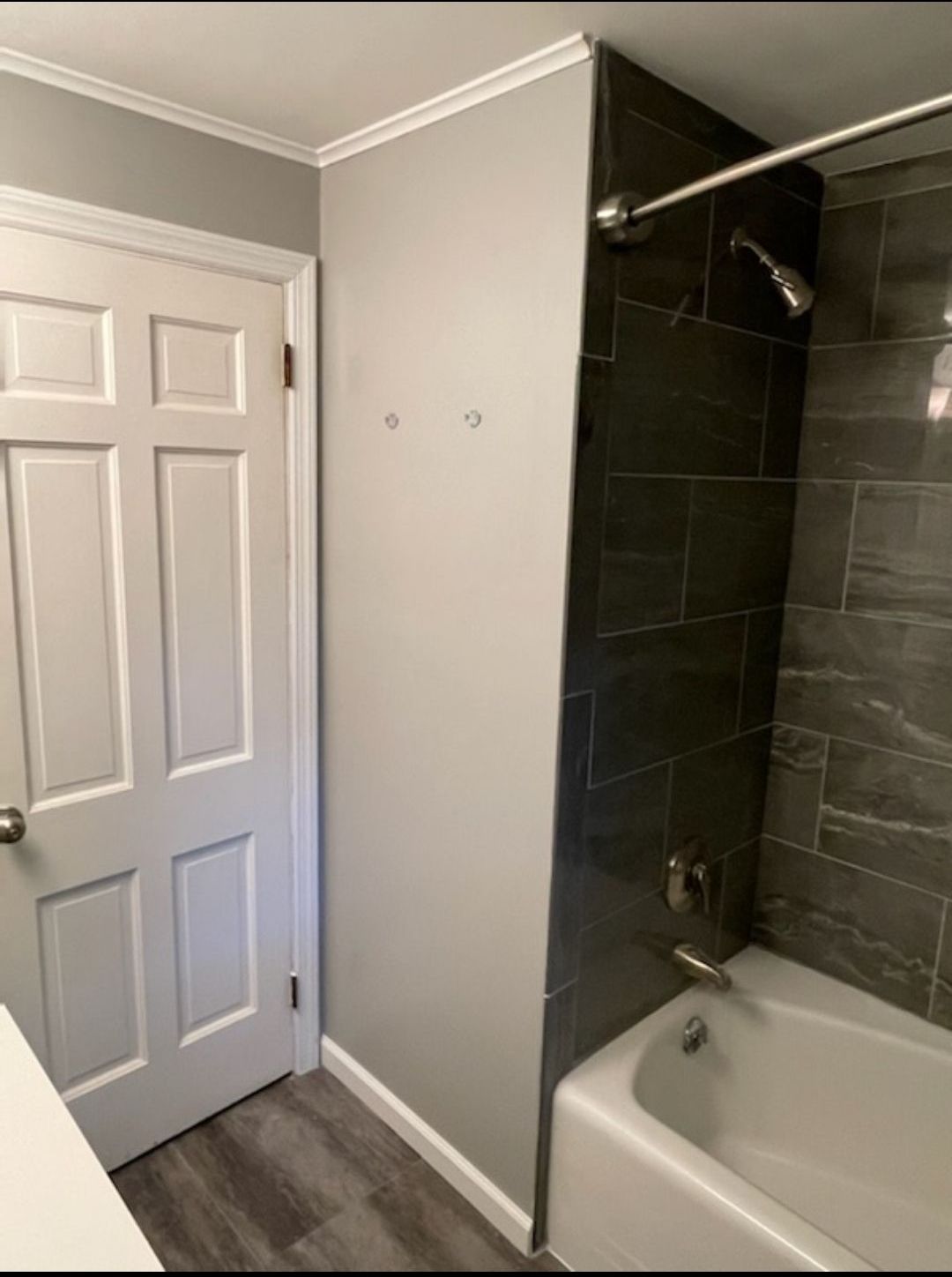 A bathroom with a bathtub and a shower.