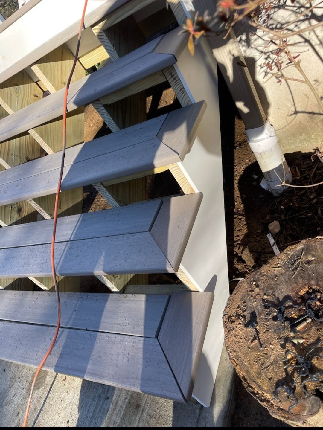 A wooden staircase is being built on a deck
