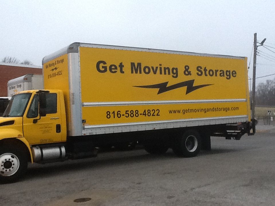 A yellow truck that says get moving and storage