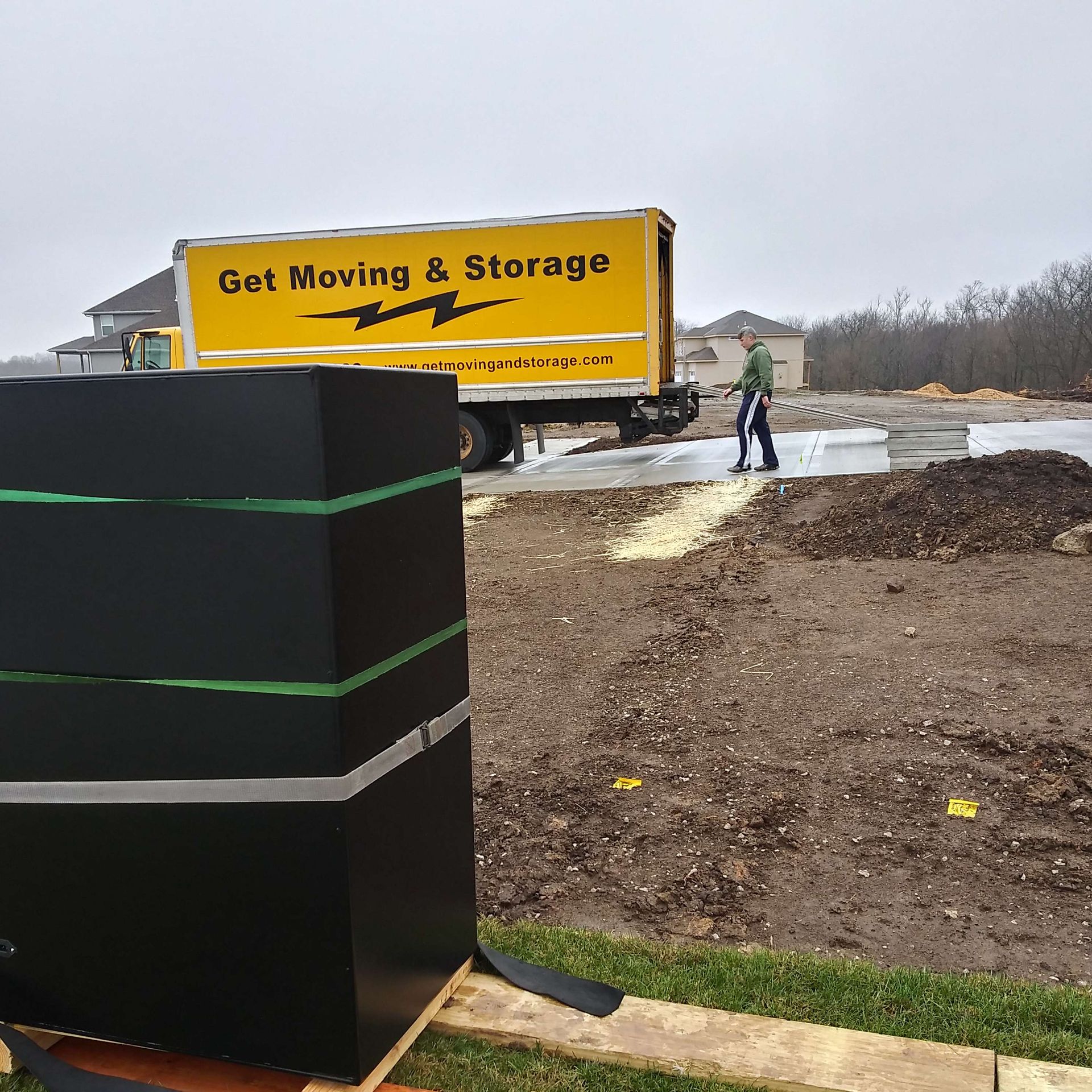 A yellow truck that says get moving & storage