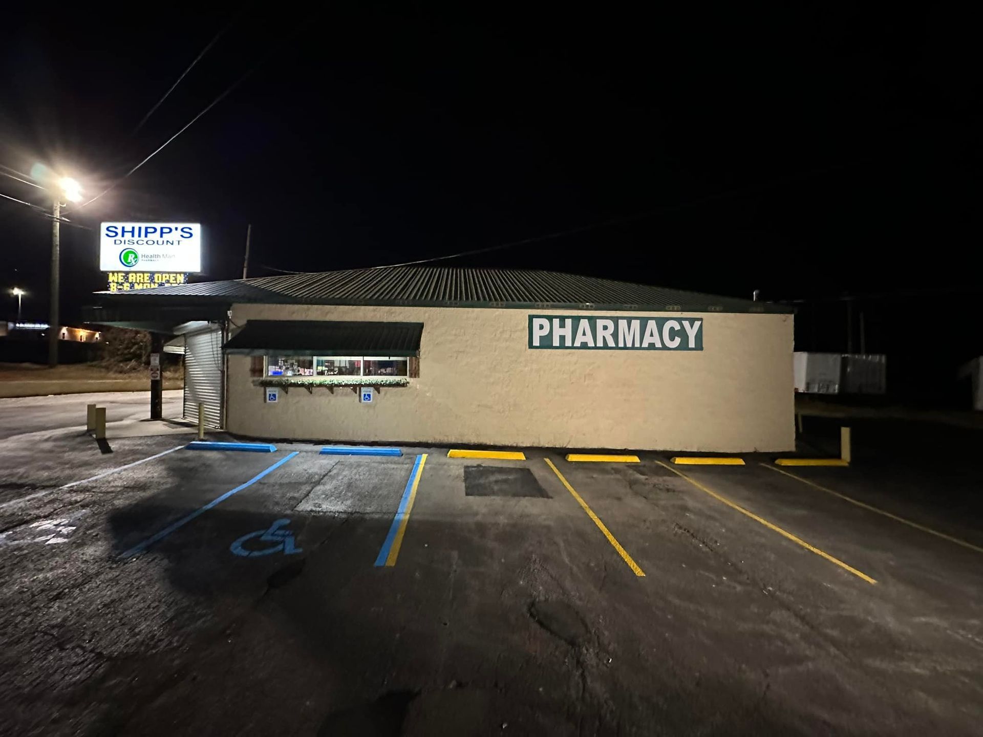 Pharmacy building at night with 