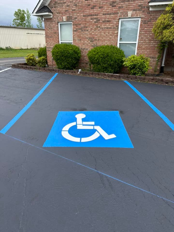 Handicap parking space with blue painted lines and a wheelchair symbol.