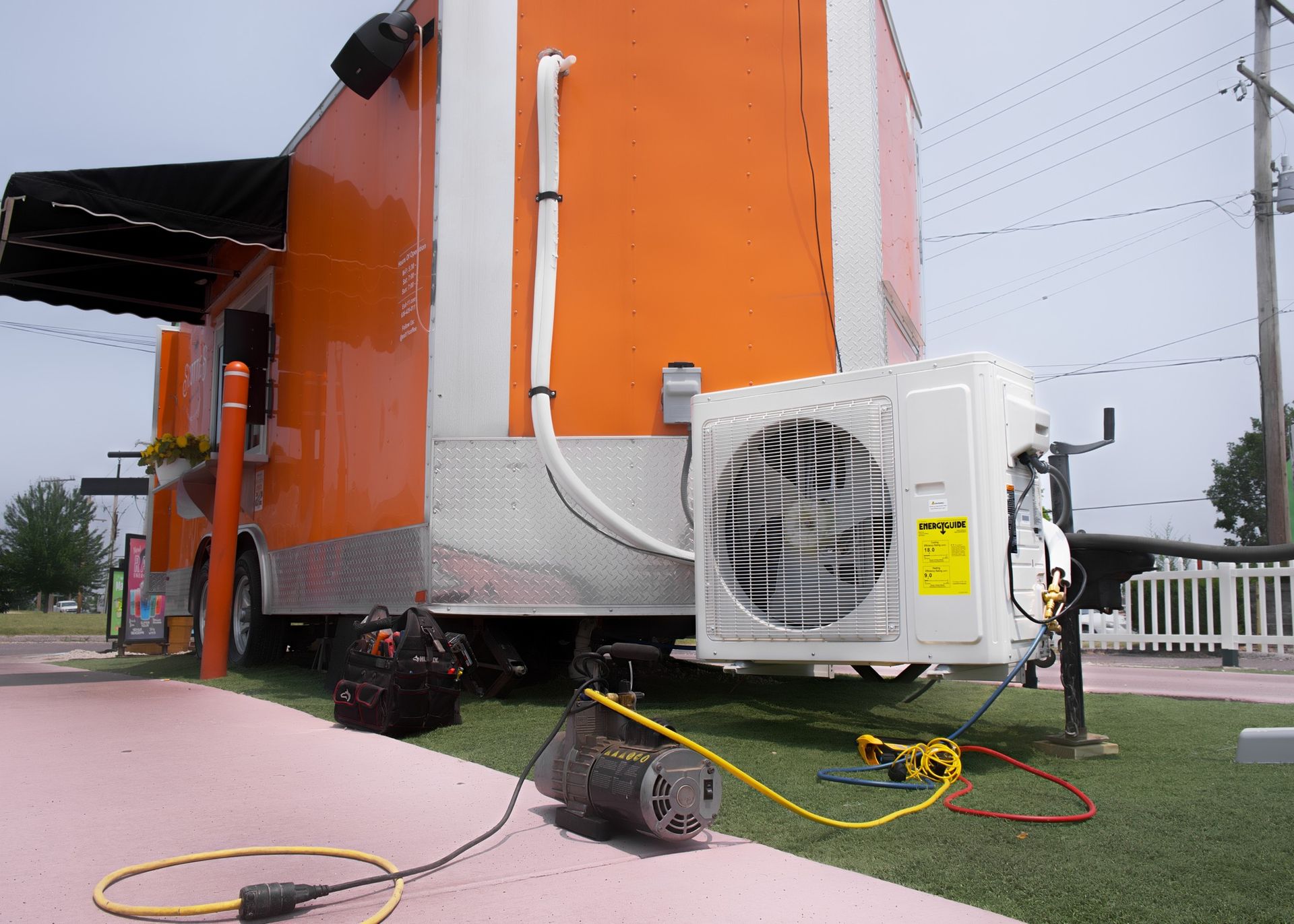 An Orange and White Food Truck with An Air Conditioner Attached to It | Union, MO | Menke Heating and Cooling