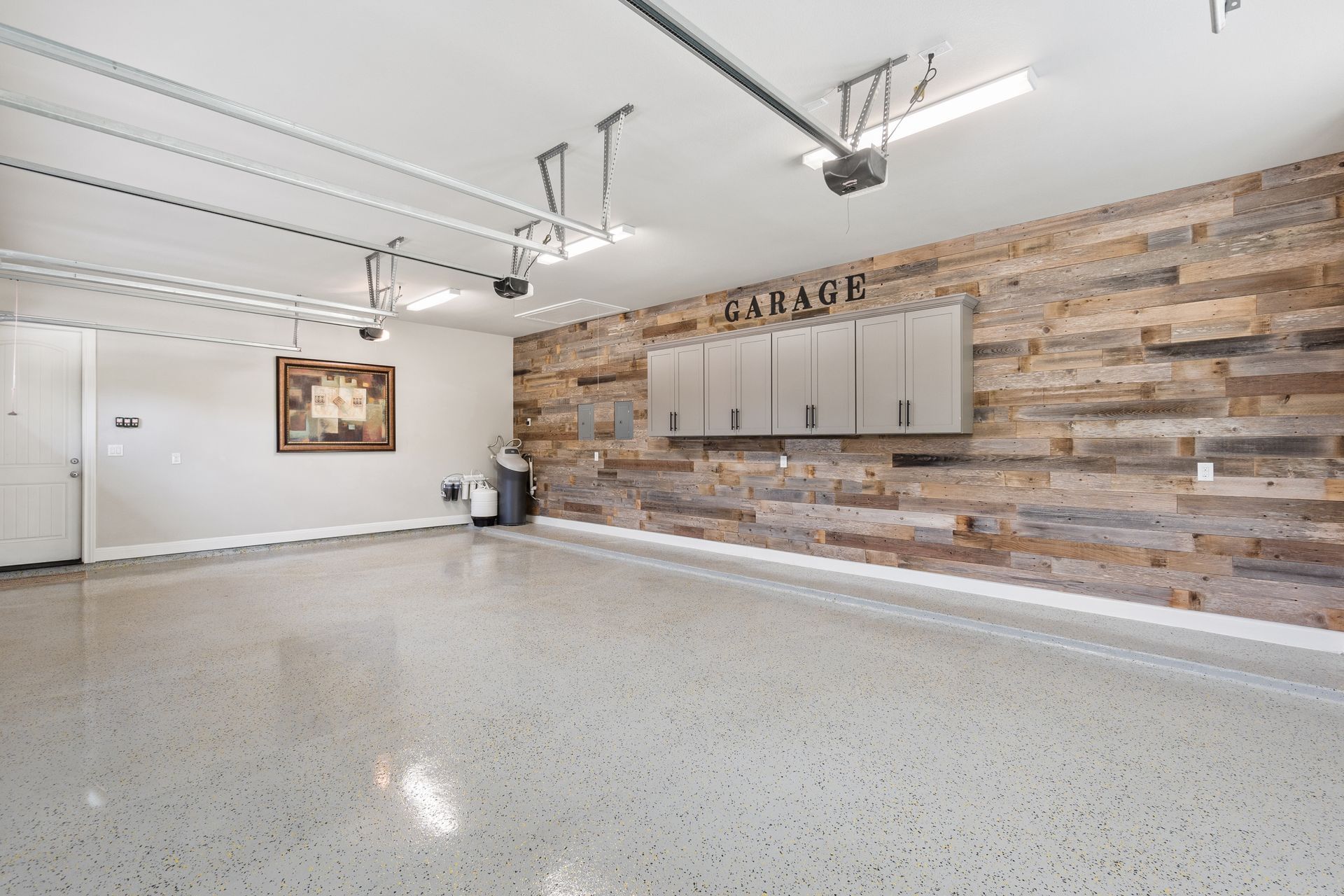 A garage with a wooden wall and a concrete floor.