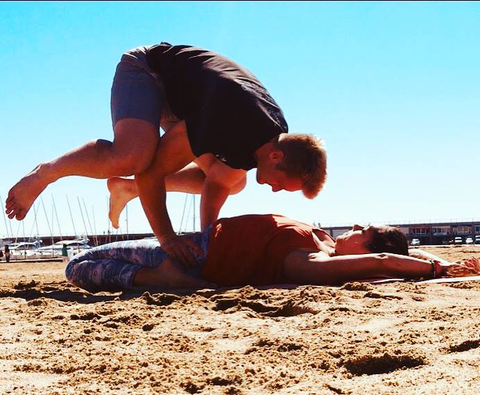 Xander Clemens with Emily Worsnop in Barcelona practicing yoga.