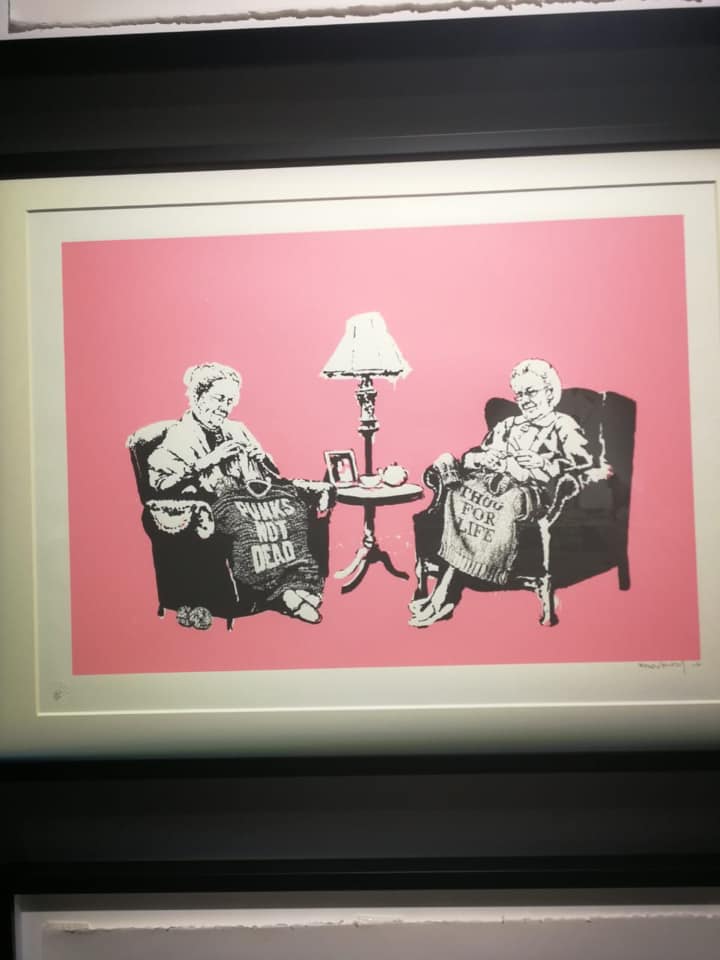 Banksy artwork of two ladies knitting shirts