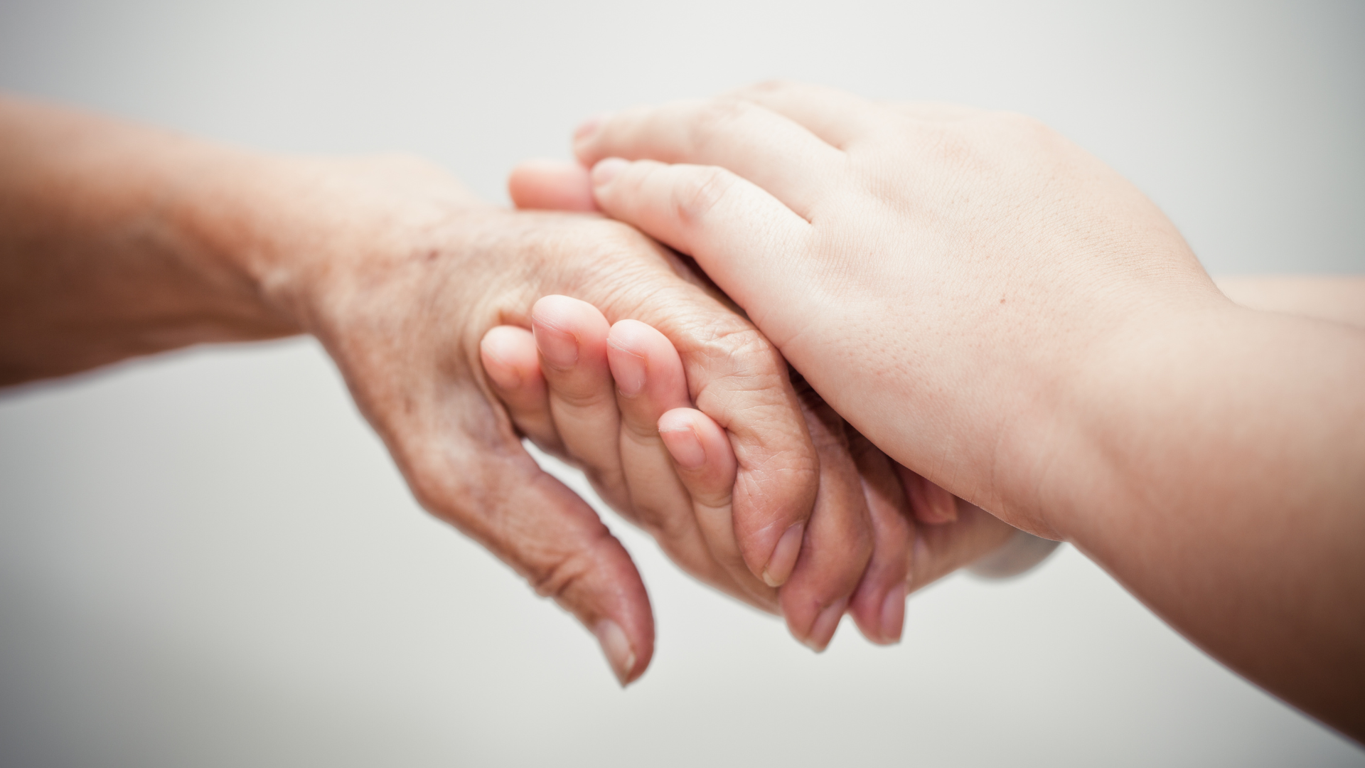 Comforting hands at a hospice care unit.