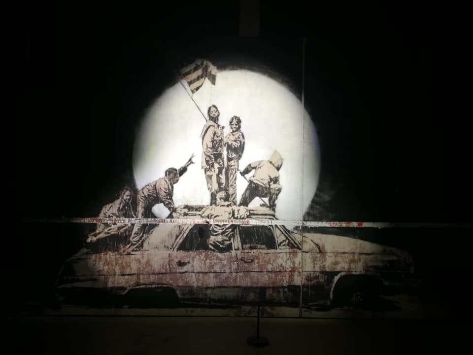 Image of the artist Banksy and there artwork.