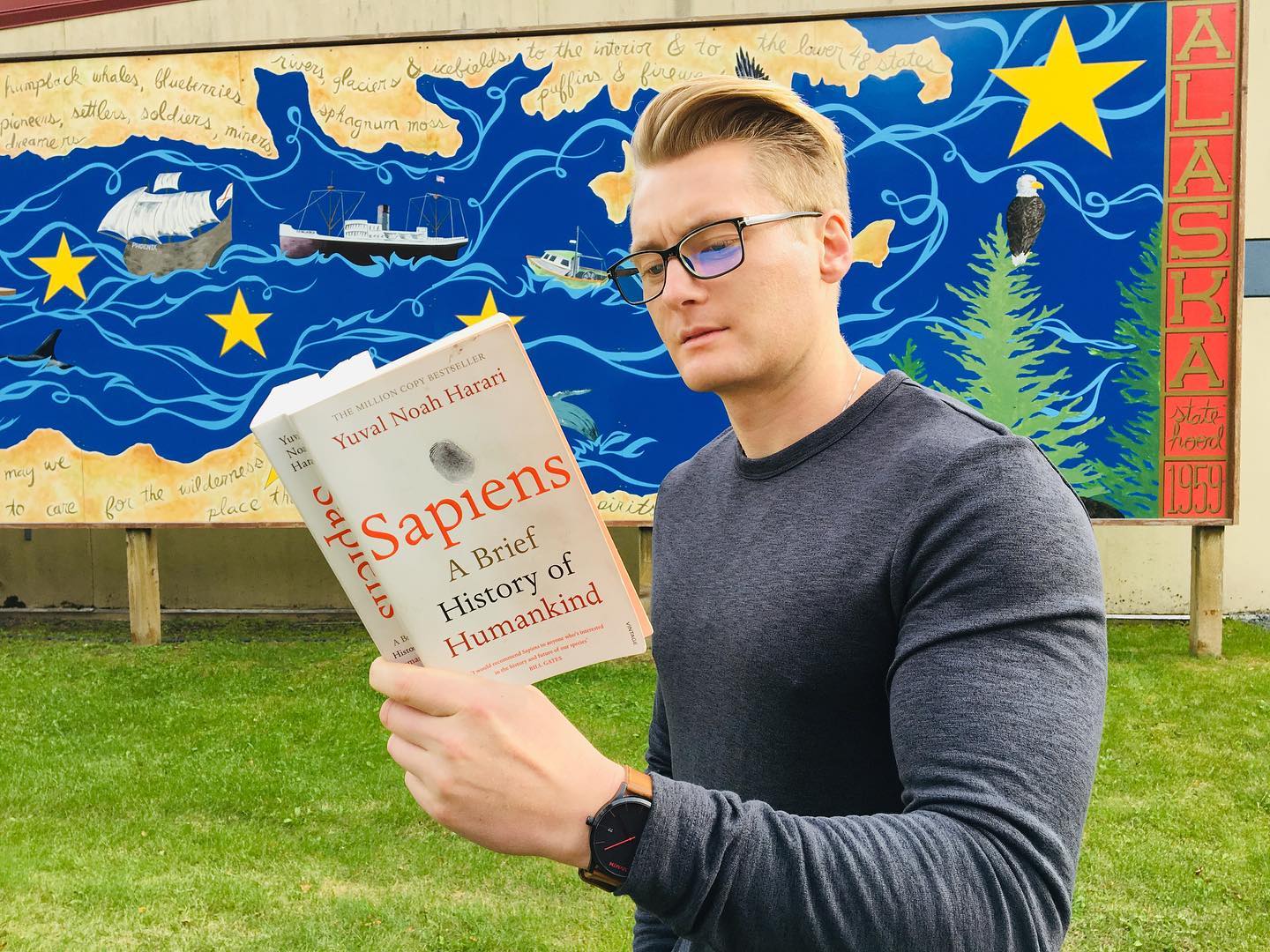 Xander Clemens is in Seward, Alaska reading the book Sapiens by Yuval Noah Harari