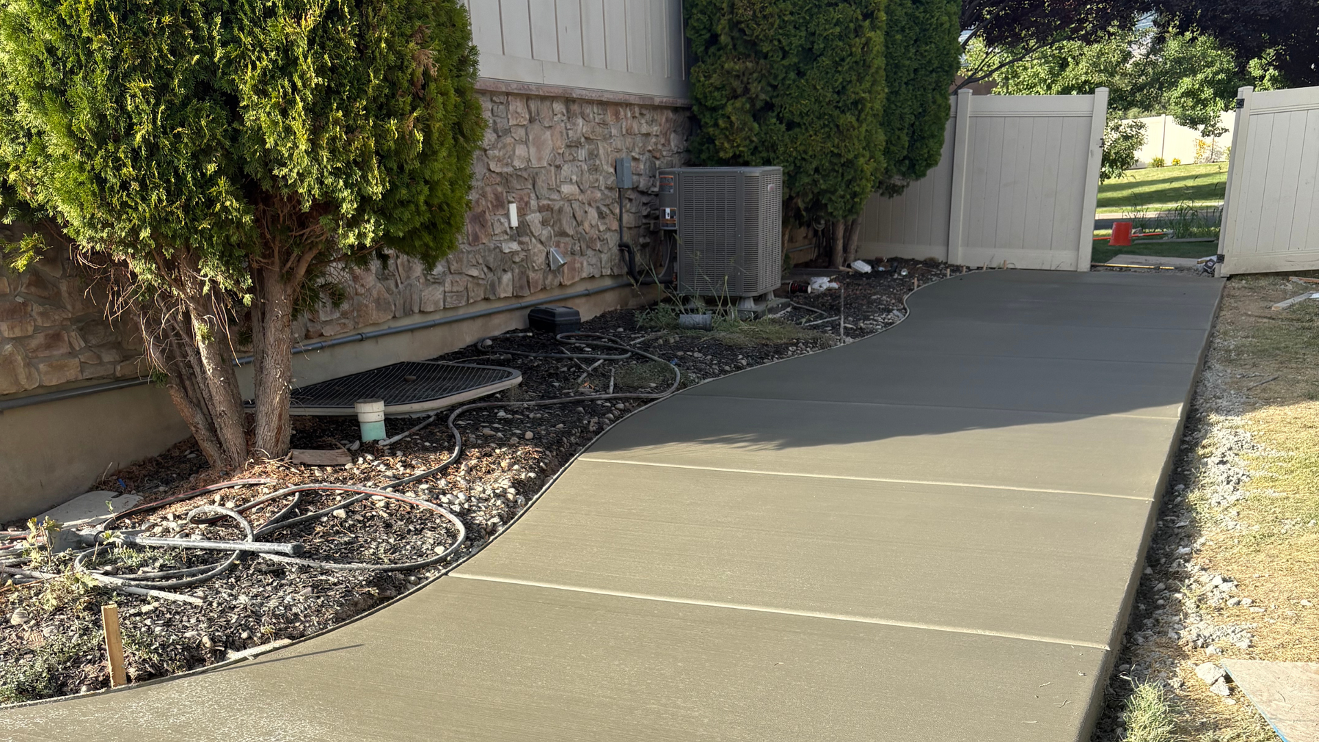 New broom-finish concrete walkway leading to a home entrance in Syracuse Utah