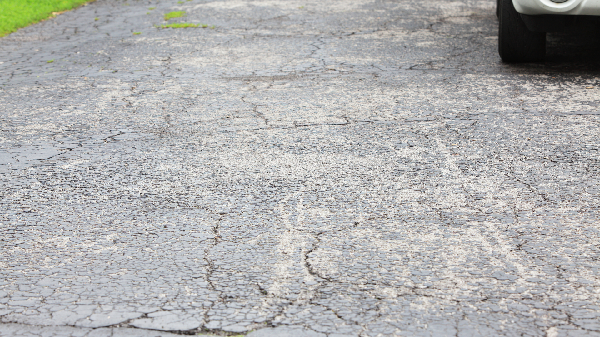 Concrete driveway with visible cracks showing early signs of surface and structural damage