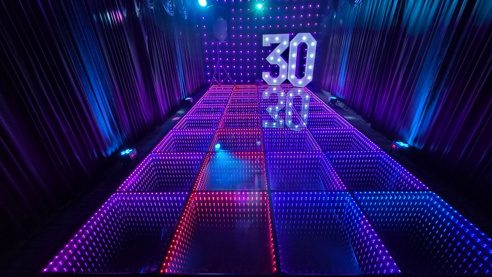 Our new LED Infinity dance floor for hire in Manchester inside our black party tent