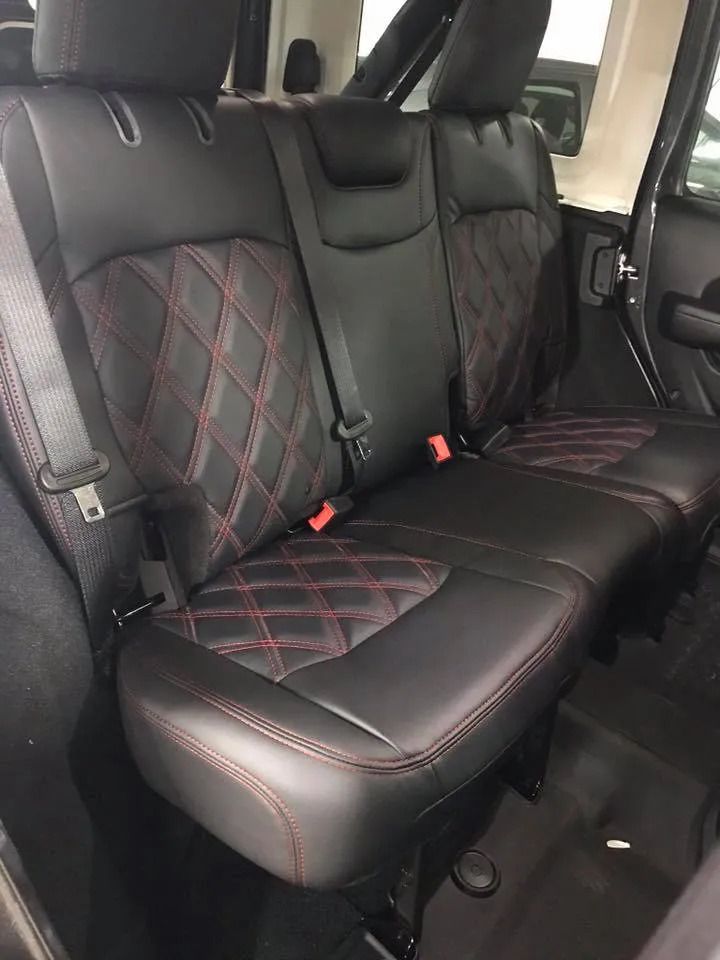 The back seats of a jeep wrangler are black and red
