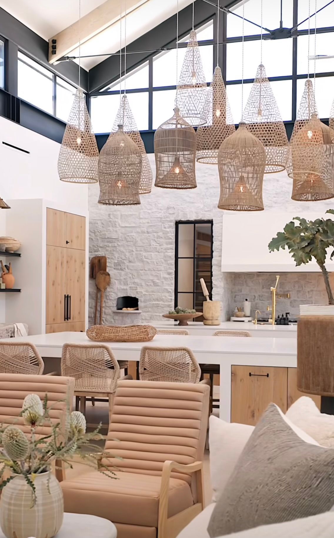 Bright rustic cafe with woven pendant lights, wooden chairs, and white brick walls under a high ceiling