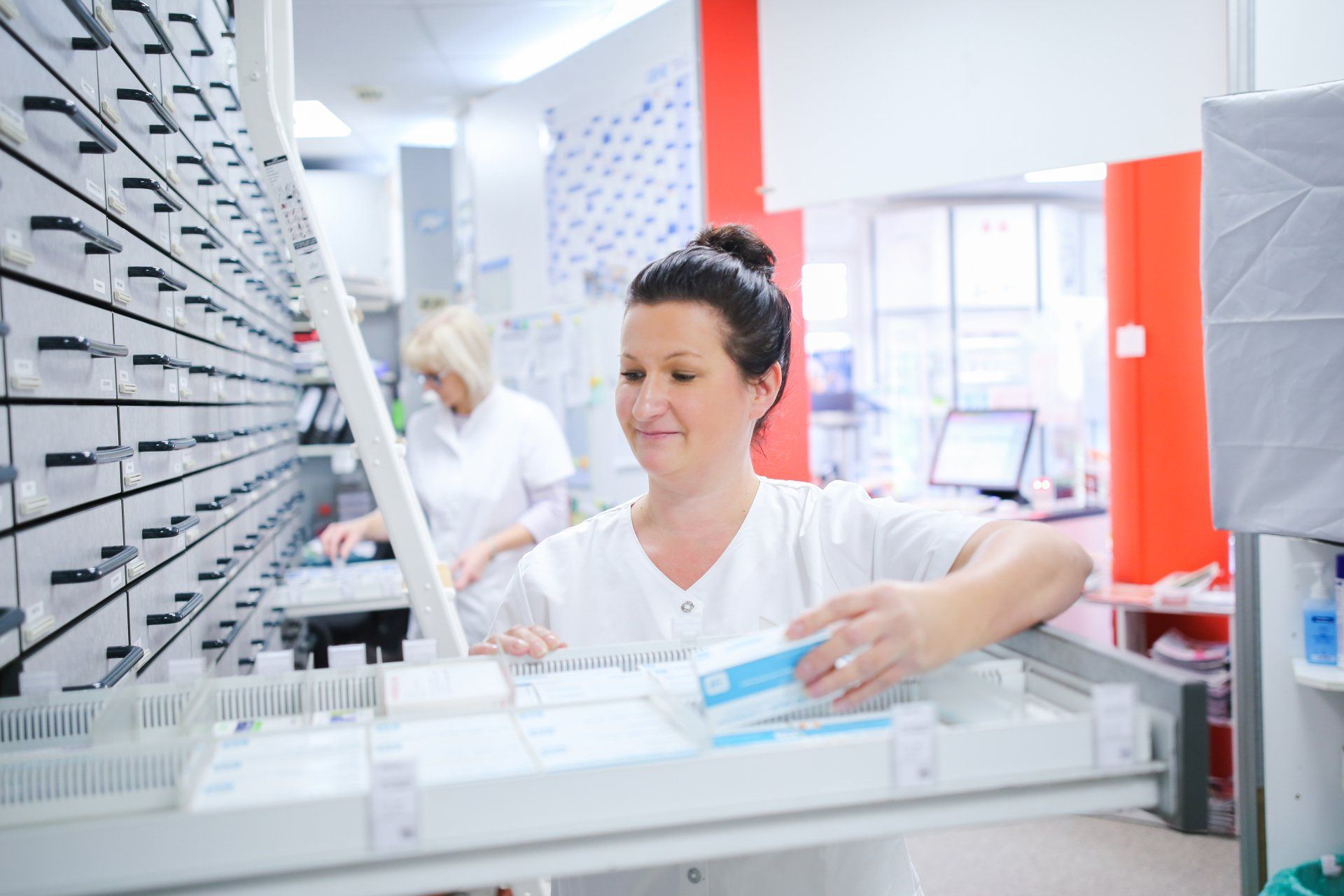 Eine Apothekerin arbeitet in einer Apotheke.